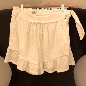 New white polyester and spandex shorts; 14 in. from waist to bottom; sids tie